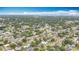 Overhead perspective of a dense, green residential area with a body of water and airport runway at 1737 Prince Philip St, Clearwater, FL 33755