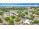 Panoramic aerial of a neighborhood featuring tree-lined streets, residences and lush vegetation at 1737 Prince Philip St, Clearwater, FL 33755