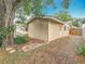 Back of house with brick path and large tree at 1737 Prince Philip St, Clearwater, FL 33755