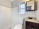 Tiled bathroom featuring a shower, toilet, vanity with granite countertop, and mirror at 1737 Prince Philip St, Clearwater, FL 33755