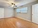 Bedroom featuring hardwood floors, ceiling fan, blinds, and two doors at 1737 Prince Philip St, Clearwater, FL 33755