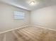 Neutral bedroom with carpet flooring, window with blinds, and basic lighting at 1737 Prince Philip St, Clearwater, FL 33755