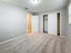 Bedroom with light gray walls, neutral carpet, a closet, and a view into the adjacent hallway at 1737 Prince Philip St, Clearwater, FL 33755