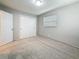 Neutral bedroom featuring carpet, gray walls, a window, and a double-door closet for ample storage at 1737 Prince Philip St, Clearwater, FL 33755