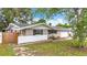 Street view of a single-story home with an attached two-car garage and landscaped front yard at 1737 Prince Philip St, Clearwater, FL 33755