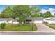 Charming single-story home with a well-maintained lawn, driveway, and attached two-car garage at 1737 Prince Philip St, Clearwater, FL 33755