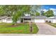 Charming single-story home with a well-maintained lawn, driveway, and attached two-car garage at 1737 Prince Philip St, Clearwater, FL 33755
