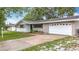 Charming single-story home with a well-maintained lawn and attached one car garage at 1737 Prince Philip St, Clearwater, FL 33755