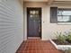 Inviting front entrance with black front door, brick landing and manicured landscaping at 1737 Prince Philip St, Clearwater, FL 33755