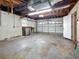 View of the spacious garage with garage door and access door at 1737 Prince Philip St, Clearwater, FL 33755