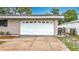 Attached one car garage featuring a white door with decorative windows and address numbers at 1737 Prince Philip St, Clearwater, FL 33755
