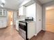 Kitchen featuring stainless steel range oven and white cabinetry with hardwood flooring in background at 1737 Prince Philip St, Clearwater, FL 33755