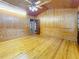 Bright living room with wood paneling, wainscoting, and hardwood floors, and interior access doors at 1737 Prince Philip St, Clearwater, FL 33755