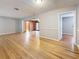 Living room with light gray walls and hardwood floors, showing a doorway into another room at 1737 Prince Philip St, Clearwater, FL 33755
