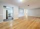Hardwood floors and light gray walls with an entrance into the kitchen on the left of the image at 1737 Prince Philip St, Clearwater, FL 33755