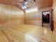 View of the living room with wood paneling, wainscoting, and hardwood floors, flowing into another room at 1737 Prince Philip St, Clearwater, FL 33755