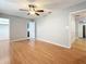 Spacious primary bedroom with hardwood floors, ceiling fan, and open doorway at 1737 Prince Philip St, Clearwater, FL 33755
