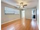 Primary bedroom with hardwood flooring, ceiling fan, and en suite bathroom at 1737 Prince Philip St, Clearwater, FL 33755