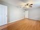 Primary bedroom featuring hardwood floors, ceiling fan, and open doorways at 1737 Prince Philip St, Clearwater, FL 33755