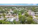 Scenic aerial shot of a neighborhood with a mix of homes, landscaping, and a glimpse of a nearby lake at 1737 Prince Philip St, Clearwater, FL 33755