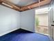Shed interior with a blue carpet and white walls looks to an outdoor space at 1737 Prince Philip St, Clearwater, FL 33755