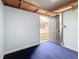 Interior shot of shed features a blue carpet, white walls, and a door leading to the outside at 1737 Prince Philip St, Clearwater, FL 33755