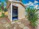 A neutral colored shed with an open door highlights the potential of storage at 1737 Prince Philip St, Clearwater, FL 33755