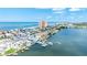 Picturesque aerial view of coastal homes, a harbor filled with boats, and the serene ocean coastline at 17817 Gulf Blvd # A, St Petersburg, FL 33708