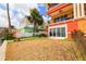 Building's backyard includes lawn and landscaping with a view of the water at 17817 Gulf Blvd # A, St Petersburg, FL 33708