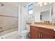 Bathroom featuring a shower-tub combo, granite vanity, and decorative fixtures at 17817 Gulf Blvd # A, St Petersburg, FL 33708