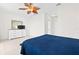 Bright bedroom featuring tile flooring, a leaf fan and a white dresser with a television at 17817 Gulf Blvd # A, St Petersburg, FL 33708