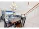 Spacious dining room with modern chandelier, staircase, and seamless flow into the living areas at 17817 Gulf Blvd # A, St Petersburg, FL 33708