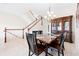 Dining room with wood table set, chandelier, china cabinet, and staircase with white railing at 17817 Gulf Blvd # A, St Petersburg, FL 33708