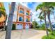 Three-story building with a two-car garage, balconies, and colorful exterior at 17817 Gulf Blvd # A, St Petersburg, FL 33708