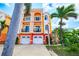 Beautiful three-story townhomes with white garages, balconies, pillars and tropical landscaping at 17817 Gulf Blvd # A, St Petersburg, FL 33708