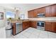 Bright kitchen with stainless steel appliances, granite countertops, and a view to the balcony at 17817 Gulf Blvd # A, St Petersburg, FL 33708