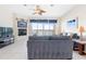 Bright living room featuring tile floors, a fireplace, ceiling fan, and access to a waterfront patio at 17817 Gulf Blvd # A, St Petersburg, FL 33708