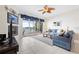Bright living room with fireplace features a sliding glass door leading to a large patio with water views at 17817 Gulf Blvd # A, St Petersburg, FL 33708