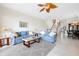 Bright living room with tile floors and ceiling fan has plenty of seating, a coffee table, and side tables at 17817 Gulf Blvd # A, St Petersburg, FL 33708