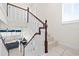 Bright staircase featuring white and wood railing and tiled flooring at 17817 Gulf Blvd # A, St Petersburg, FL 33708