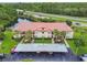 Aerial shot featuring building with palm trees, landscaping, parking and lake at 1801 E Lake Rd # 20 G, Palm Harbor, FL 34685