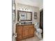Bathroom with a wooden vanity, granite countertop, large mirror with decorative lighting, and a toilet at 1801 E Lake Rd # 20 G, Palm Harbor, FL 34685