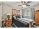 Bedroom featuring a ceiling fan, neutral walls, and a bed with stylish bedding, next to a nightstand with a lamp at 1801 E Lake Rd # 20 G, Palm Harbor, FL 34685