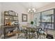 Bright dining area with a glass table, display cabinet, and natural light from a nearby window at 1801 E Lake Rd # 20 G, Palm Harbor, FL 34685