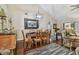 Dining room features hardwood floors and elegant chandelier, creating a warm and inviting atmosphere at 1801 E Lake Rd # 20 G, Palm Harbor, FL 34685