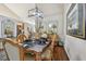 Elegant dining room with wood floors, decorative art and furniture, plus a modern light fixture at 1801 E Lake Rd # 20 G, Palm Harbor, FL 34685