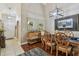 Dining area features hardwood floors, an elegant light fixture, and an adjacent entryway and a buffet at 1801 E Lake Rd # 20 G, Palm Harbor, FL 34685