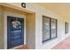 Inviting condo entrance with decorative wreath, tiled floor, and a view of natural light at 1801 E Lake Rd # 20 G, Palm Harbor, FL 34685