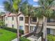 Exterior shot of building featuring landscaping and staircases at 1801 E Lake Rd # 20 G, Palm Harbor, FL 34685