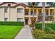 Exterior shot of building featuring well-manicured landscaping and a welcoming entryway at 1801 E Lake Rd # 20 G, Palm Harbor, FL 34685